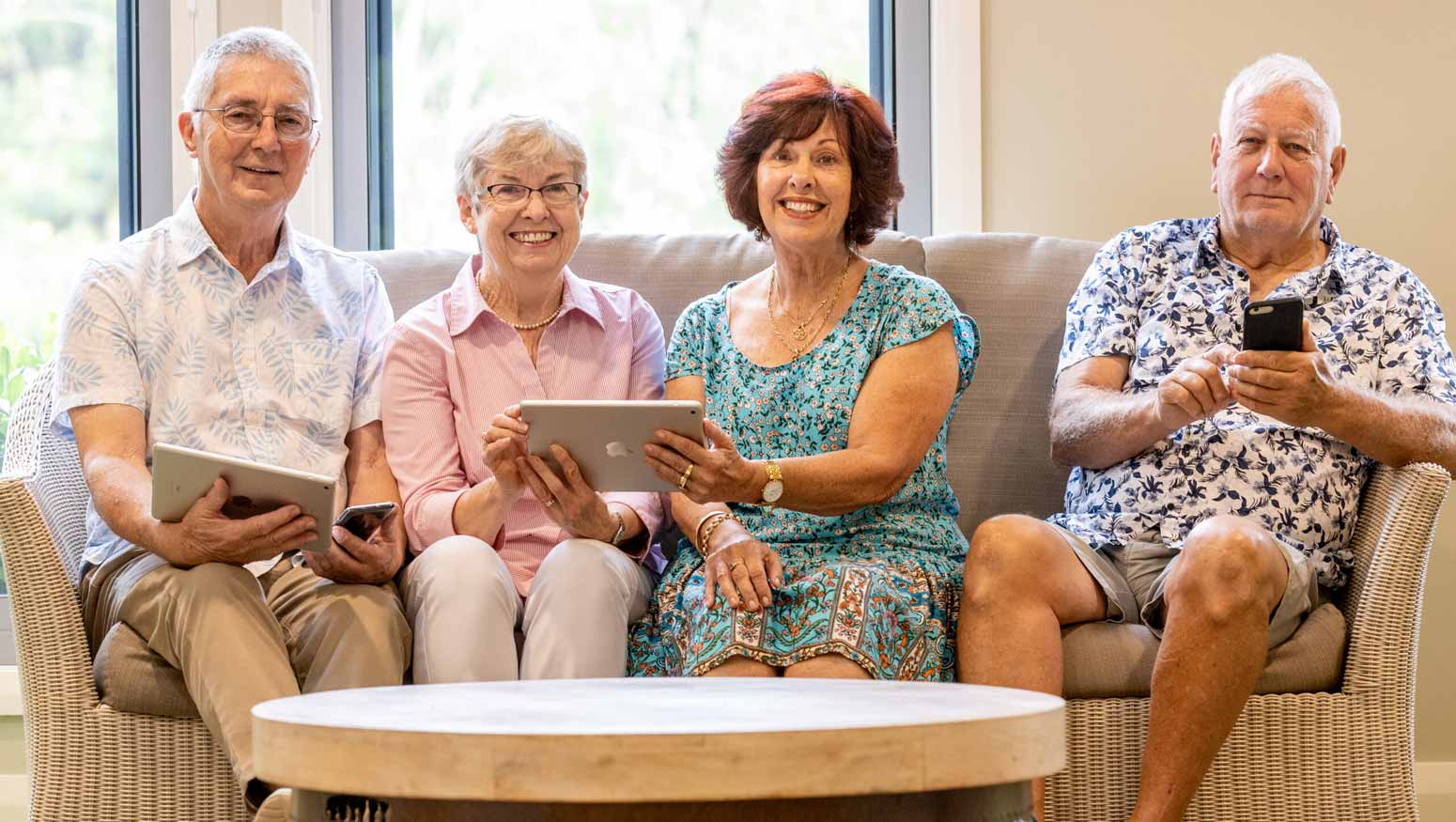 Elements retirement living residents enjoying the new Conpago app on their phones and ipad